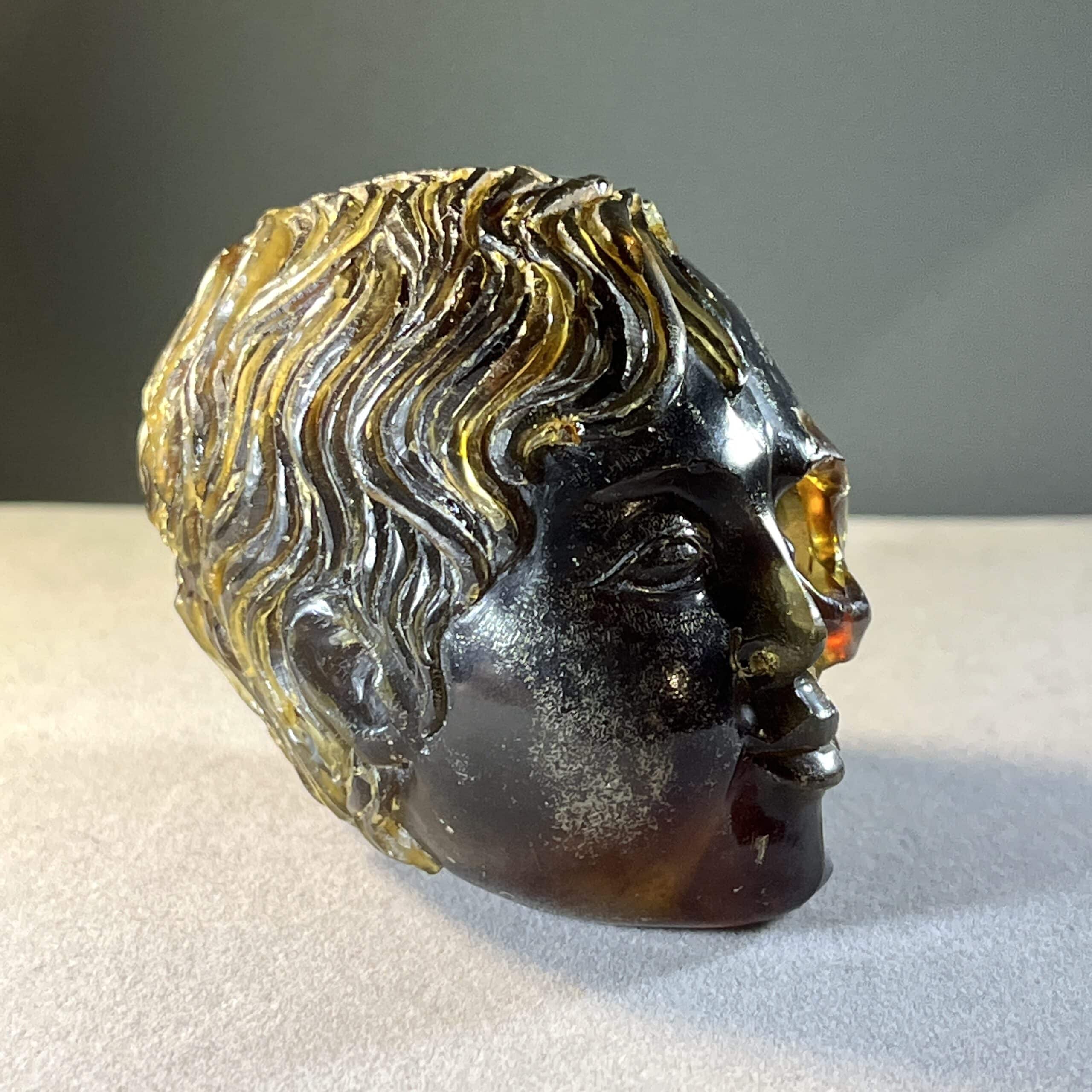 Amber (carving) blue fluorescent 'child skull within' healing crystal - Image 5