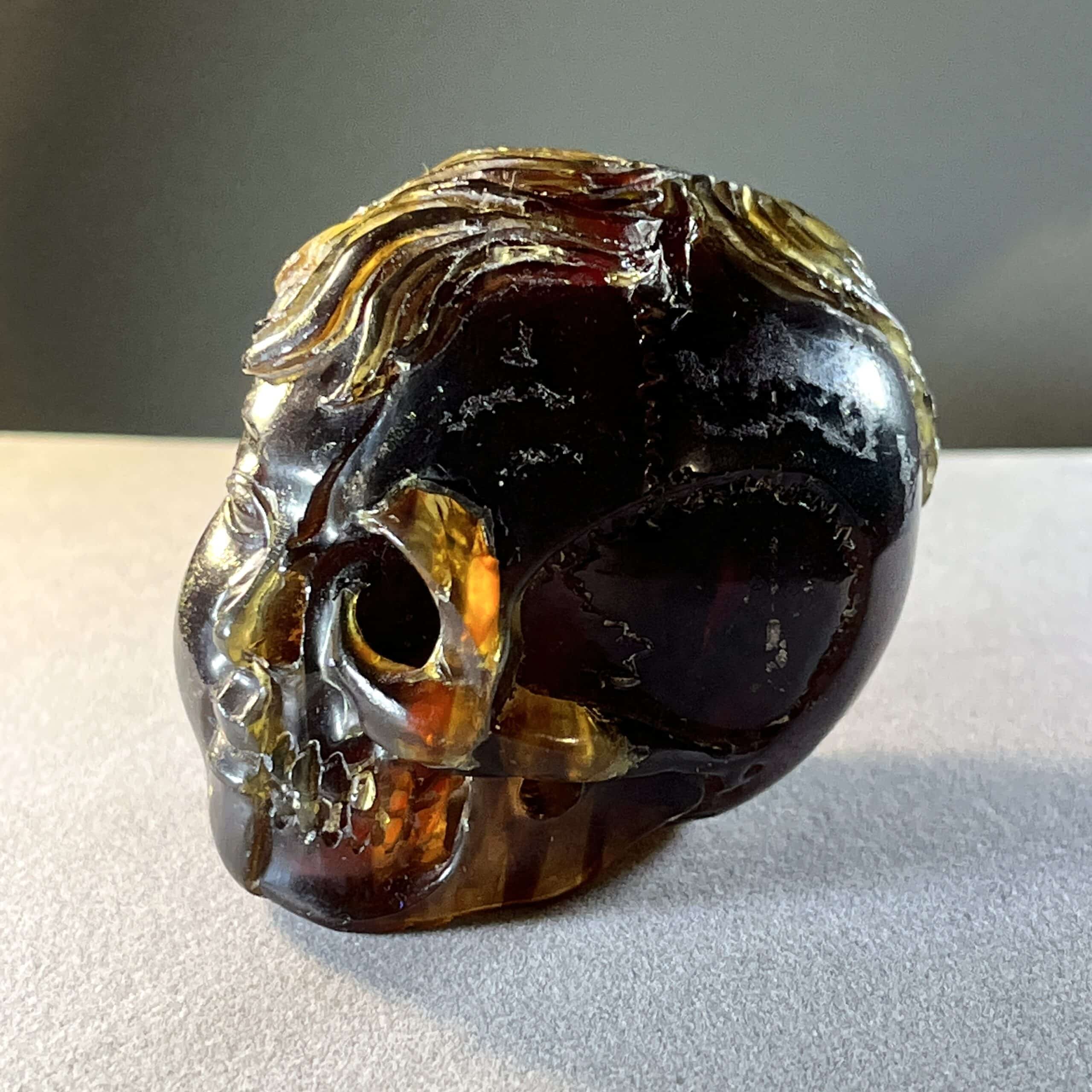 Amber (carving) blue fluorescent 'child skull within' healing crystal - Image 6
