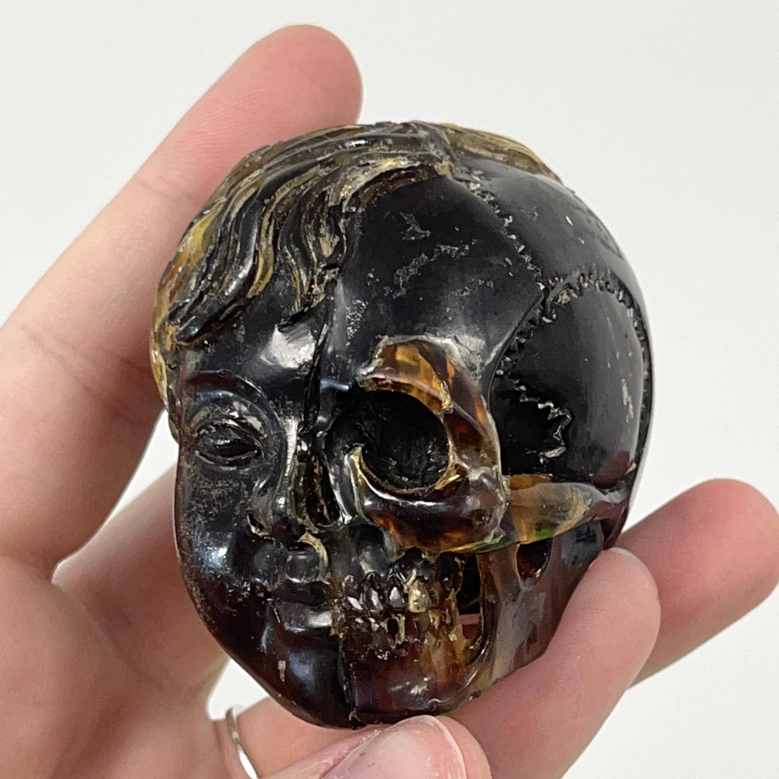 Amber (carving) blue fluorescent 'child skull within' healing crystal