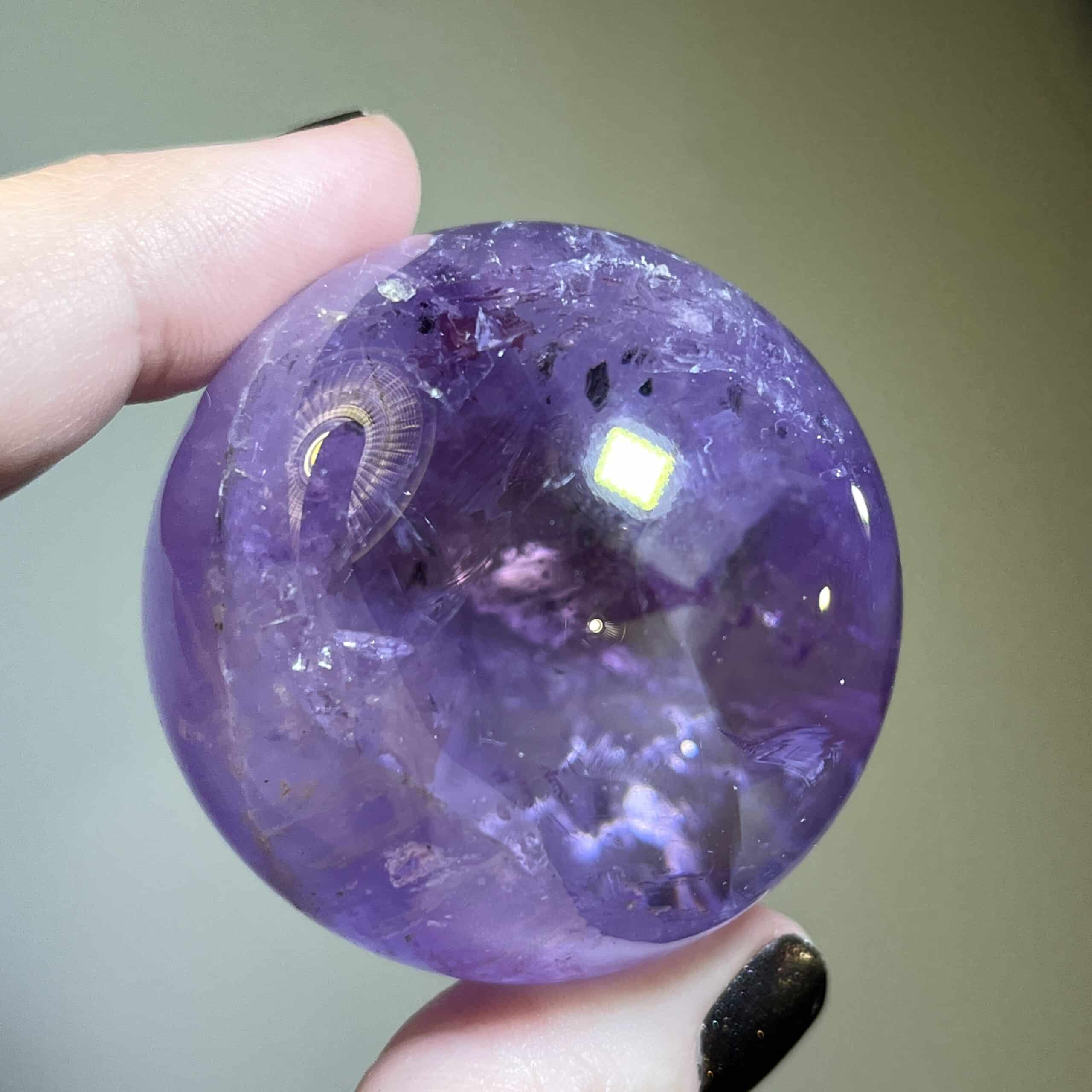 Amethyst sphere palm display piece w several rainbows, healing crystal