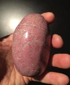 Rhodonite: light pink, polished palm piece - healing crystal