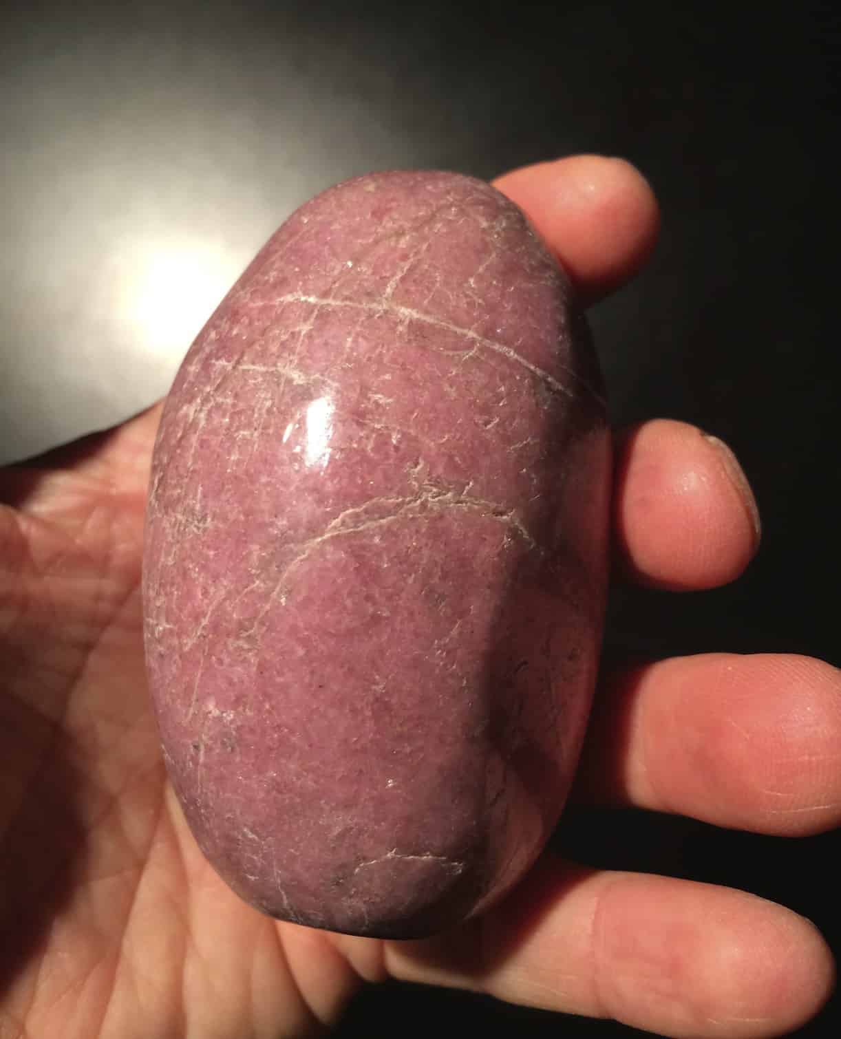 Rhodonite: light pink, polished palm piece - healing crystal