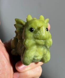 Jade-like (carving) Serpentine baby dragon, head-in-hands, healing crystal